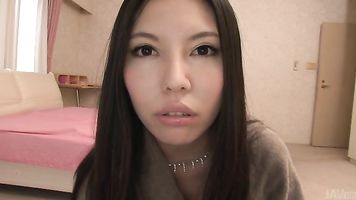 Hot Asian milf throats cock in a hotel room.