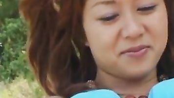 Hot Asian milf in a blue bikini sucks cock and rides it hard outdoors.