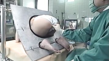 Japanese AV Model is a milf in the ass stockade getting an enema - Weird Japan.
