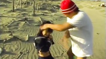 She is out playing on the beach and a guy sees her and wants to take advantage of her being alone! He catches her and is holding her down and she pisses on the beach! He roughly licks her tits and pokes her hairy pussy before turning her upside down to li